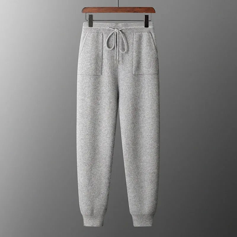Men's dark grey cashmere hooded sweatshirt and matching long pants laid flat as a complete set.