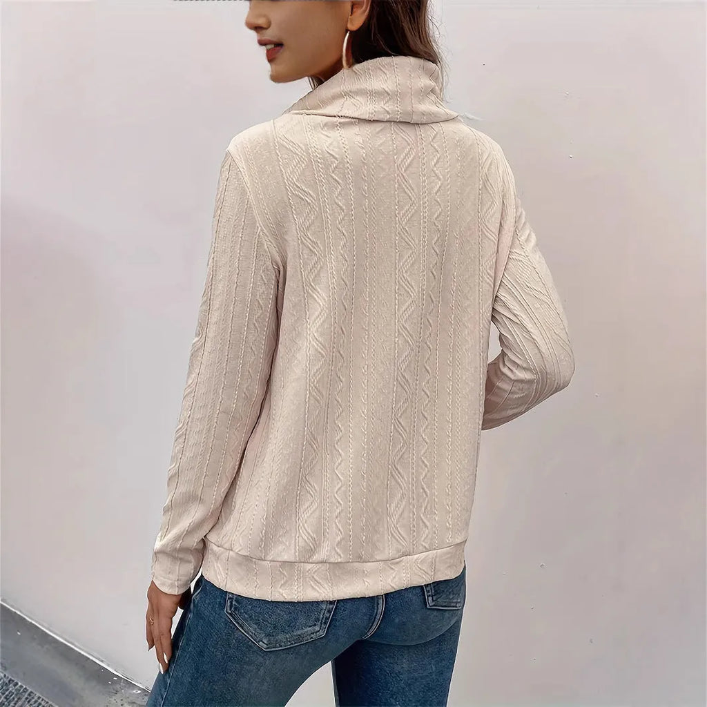 Apricot coloured women's hooded pullover sweater with long sleeves on a hanger.