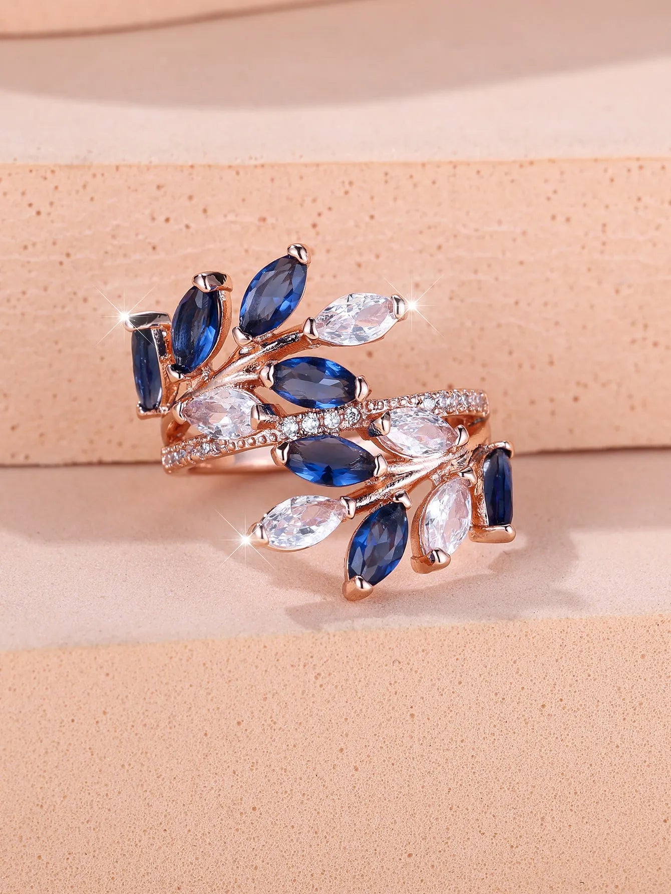 Adjustable horse eye design leaf ring in copper with zircon crystals, shown in a rose gold finish