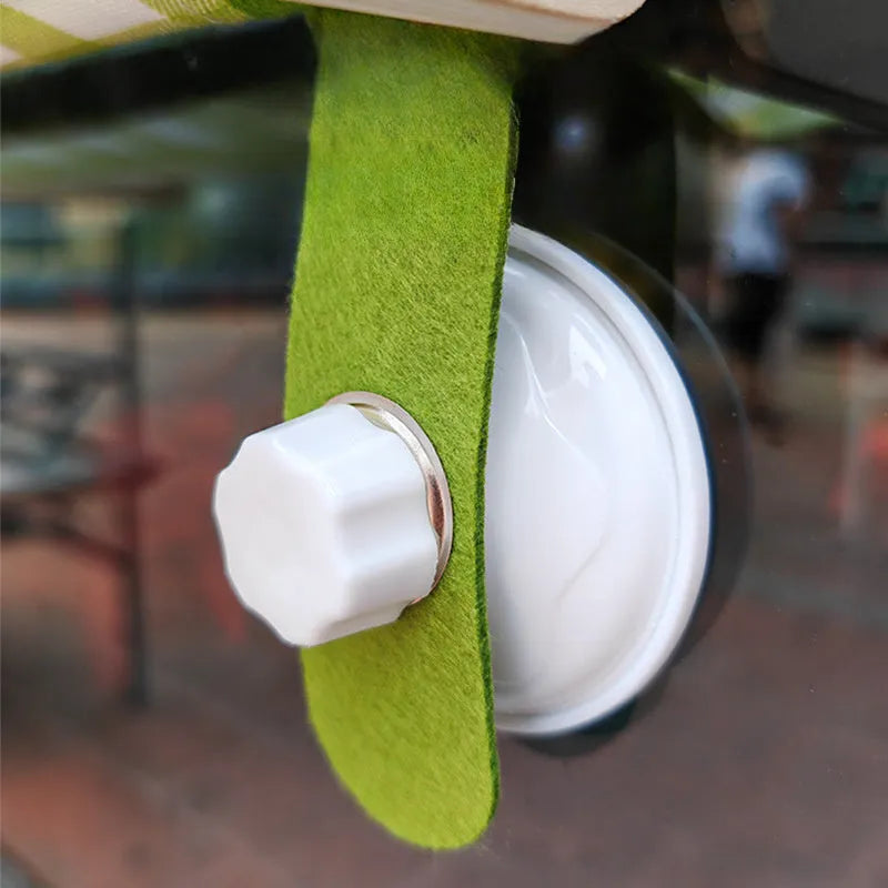 Wooden cat window hammock with suction cups on a glass window