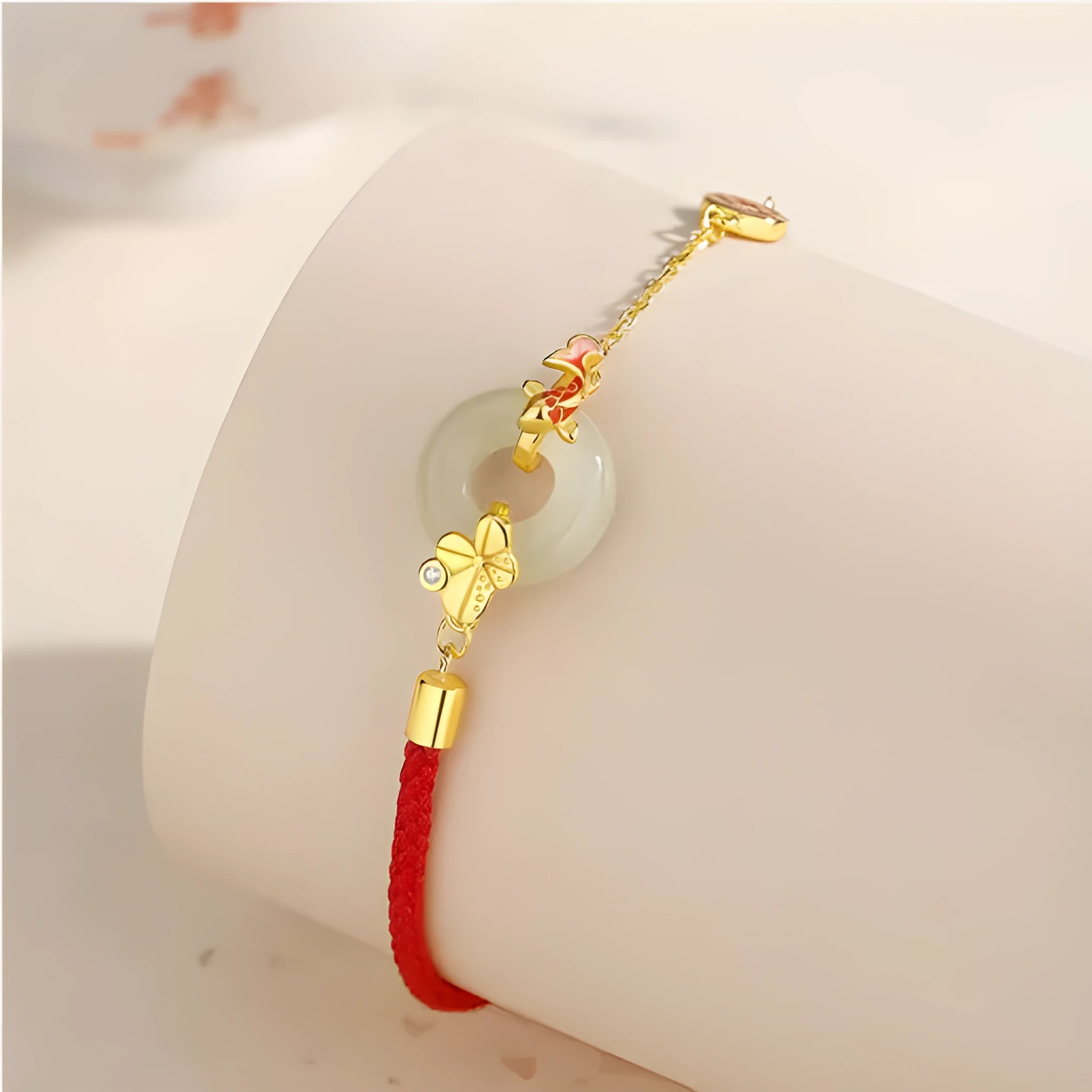 Gold electroplated 925 sterling silver bracelet with red rope and peace buckle featuring koi fish design
