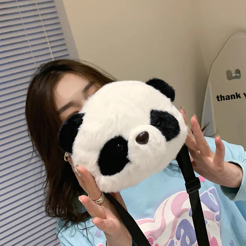 Soft plush cylindrical panda head crossbody bag showing front sandwich pocket.