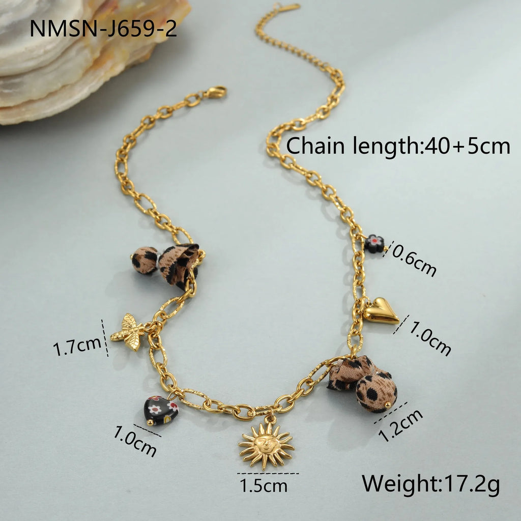 Stainless steel necklace with gold electroplated pendant showing leopard and heart flower designs
