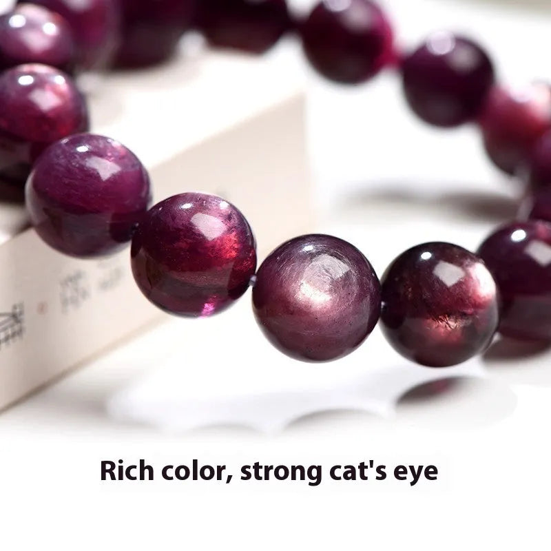 Purple lepidolite crystal bracelet showing polished round beads on adjustable string in natural lighting