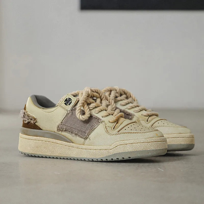 Beige low-top vintage skate shoes with lace-up front and rubber sole.