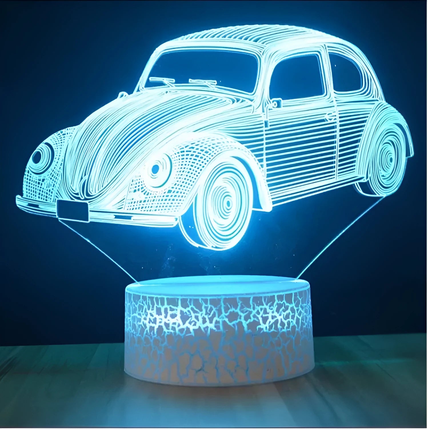 Small 3D LED table lamp with colourful acrylic shade and black ABS base, showing remote control operation
