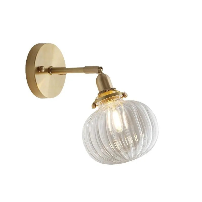 Pumpkin shaped transparent glass wall lamp with water ripple texture mounted on a wall