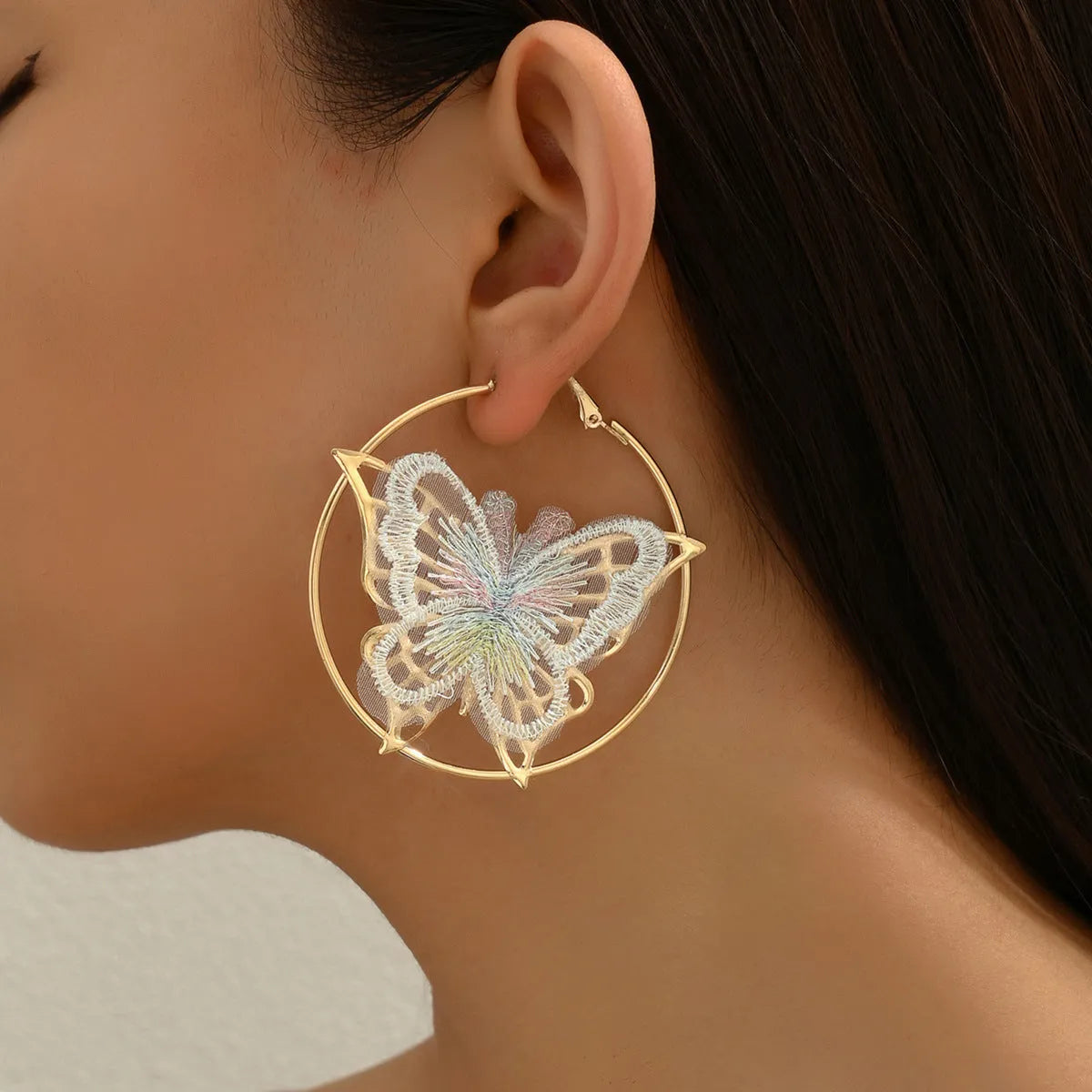 Gold butterfly clip-on earrings for women with geometric design and iron construction