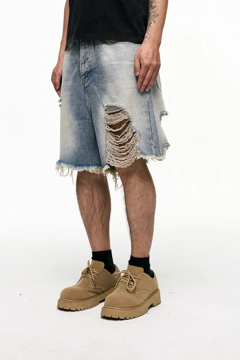 Men's light blue baggy denim shorts with a mid-rise waist and wide leg fit.