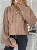 Beige women's loose round neck sweater with a twist design detail on the front.