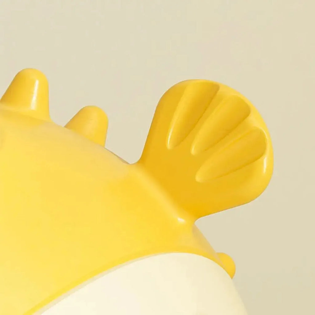Yellow fish-shaped dog chew toy with textured surface for aggressive chewers