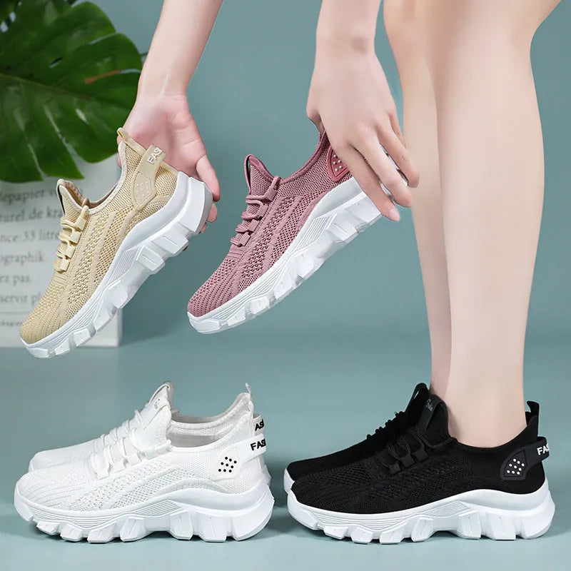 Women's white Flyknit lace-up sneakers with a thick PVC sole and round toe on a neutral background