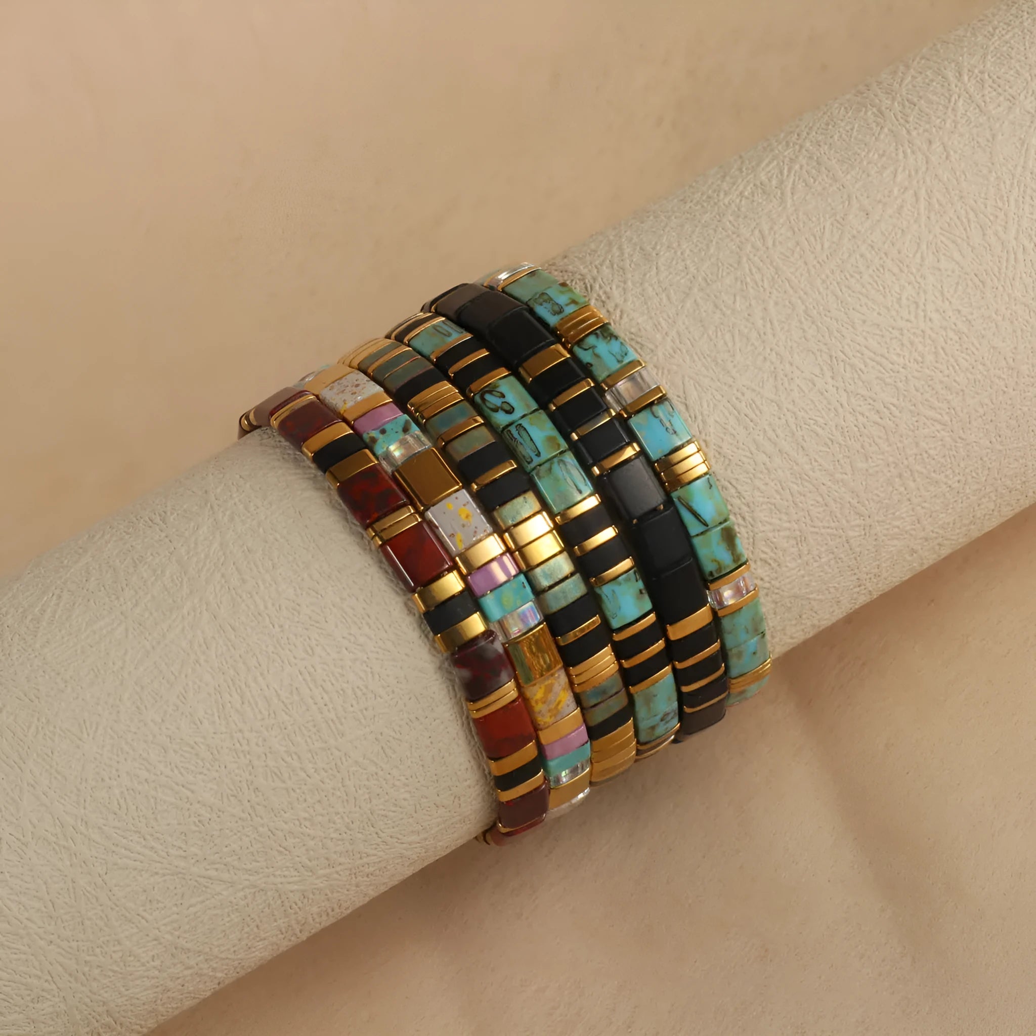 Adjustable geometric beaded bracelet with pull beads in milky white, black, green, blue or red.