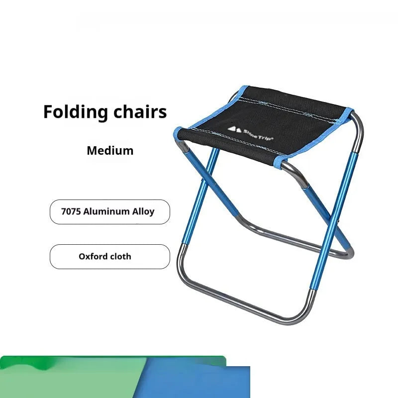 Black ethnic style folding camp stool with 7075 aluminium alloy frame in folded position.