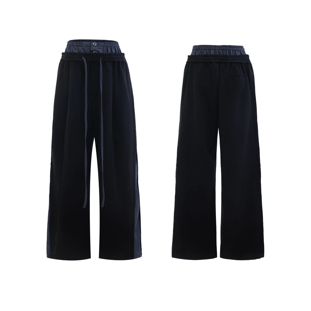 Men's black hooded short sleeve polyester sports suit with textured stitching and matching trousers on a grey background.