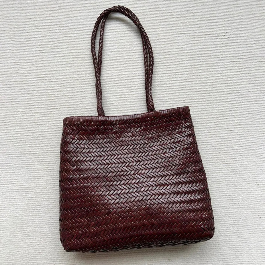 Brown woven leather tote bag with three-dimensional pockets and shoulder straps