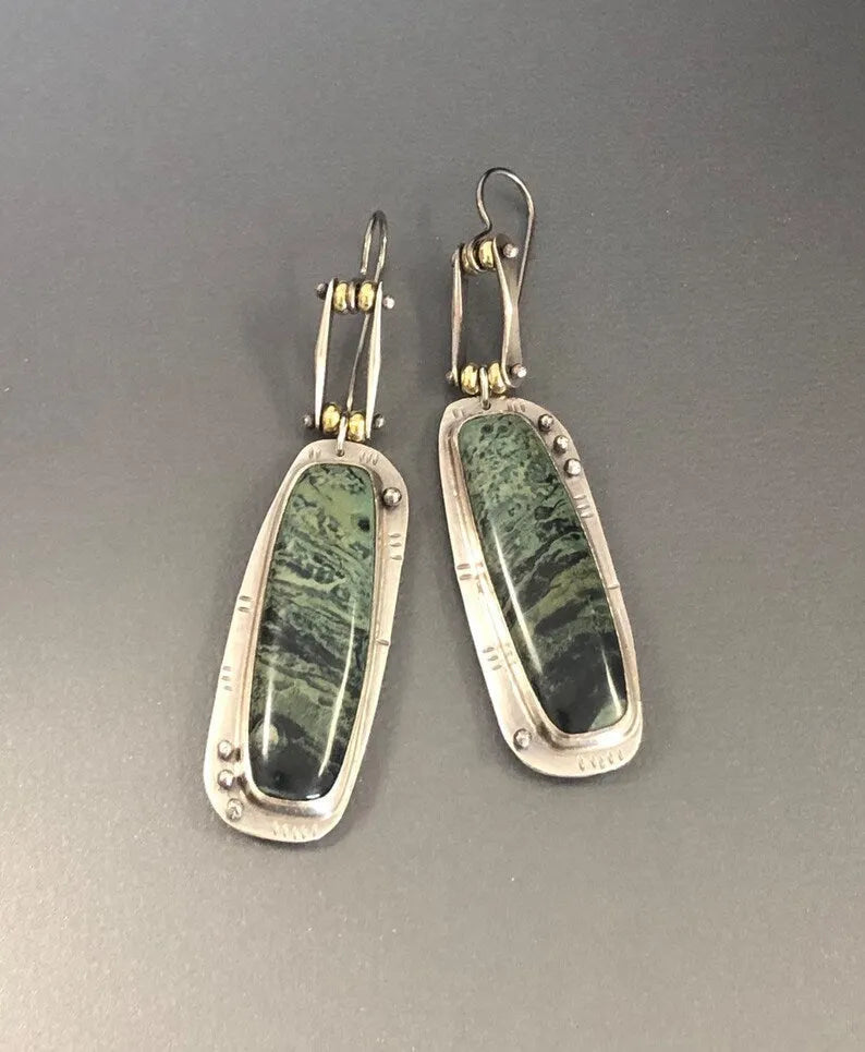 Geometric two-colour marble pattern alloy earrings on a white background.