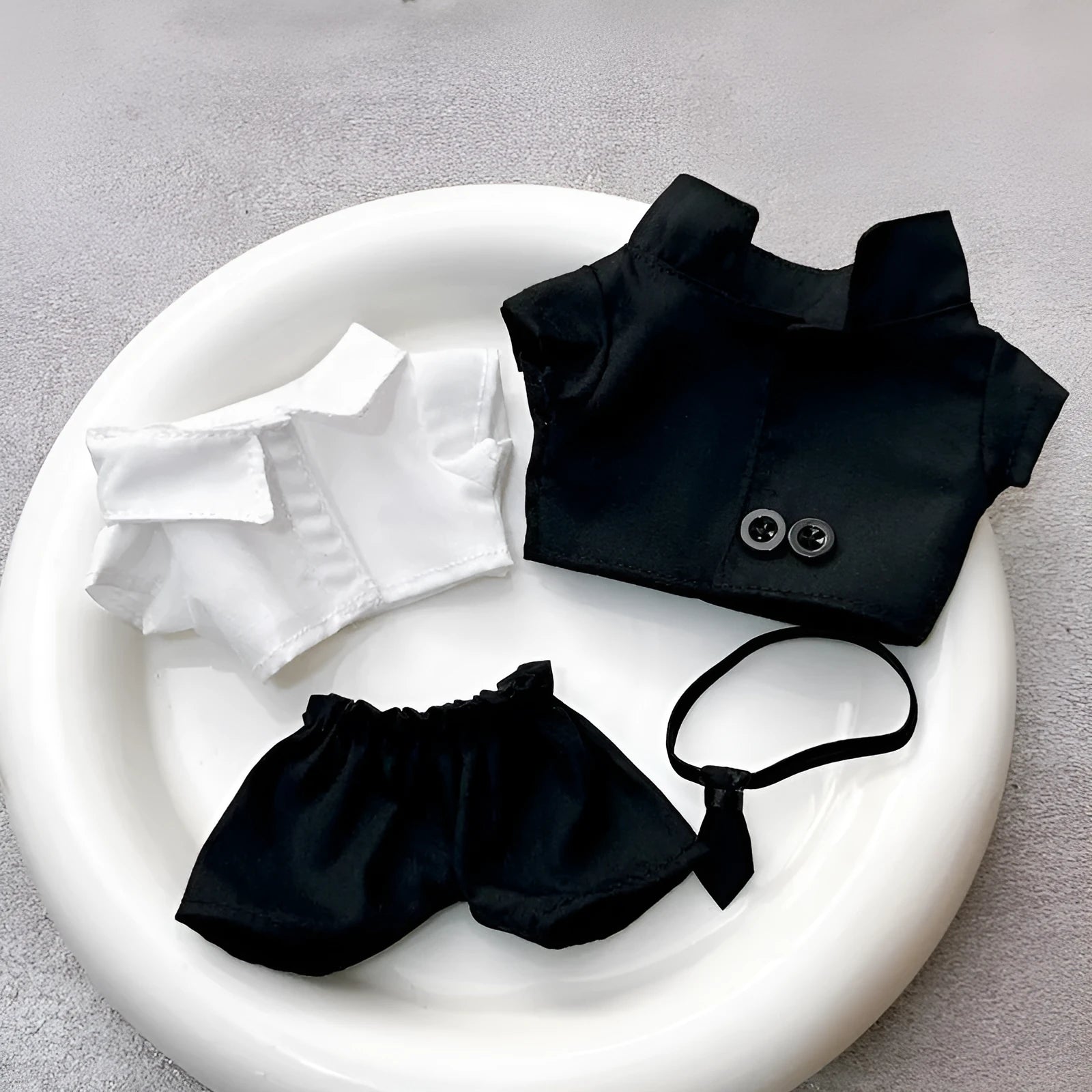 Black suit set for dolls with oval sunglasses and ankle boots, polyester material.