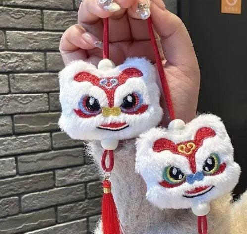 Chinese style plush lion keychain ornament with cartoon design and star stone details on blue background