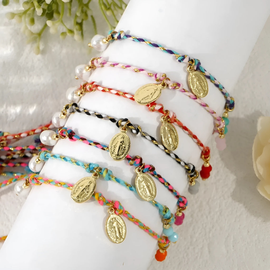 Close-up of a hand-woven ethnic bracelet for women made from colourful braided rope.