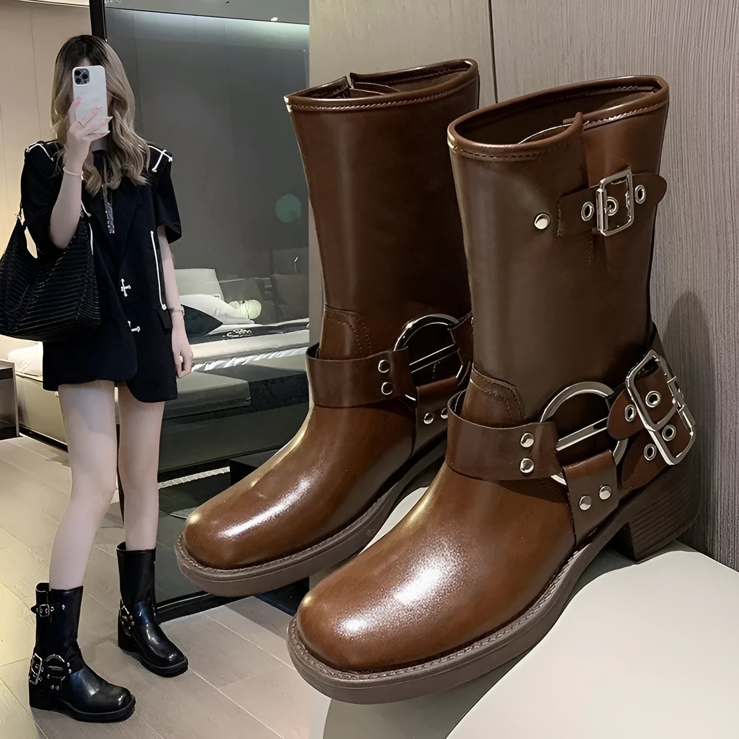 Black platform women's boot with a belt buckle on the shaft, mid-calf height.