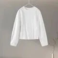 Women's black polyester fleece long sleeve top and wide leg pants two-piece suit set with pockets.