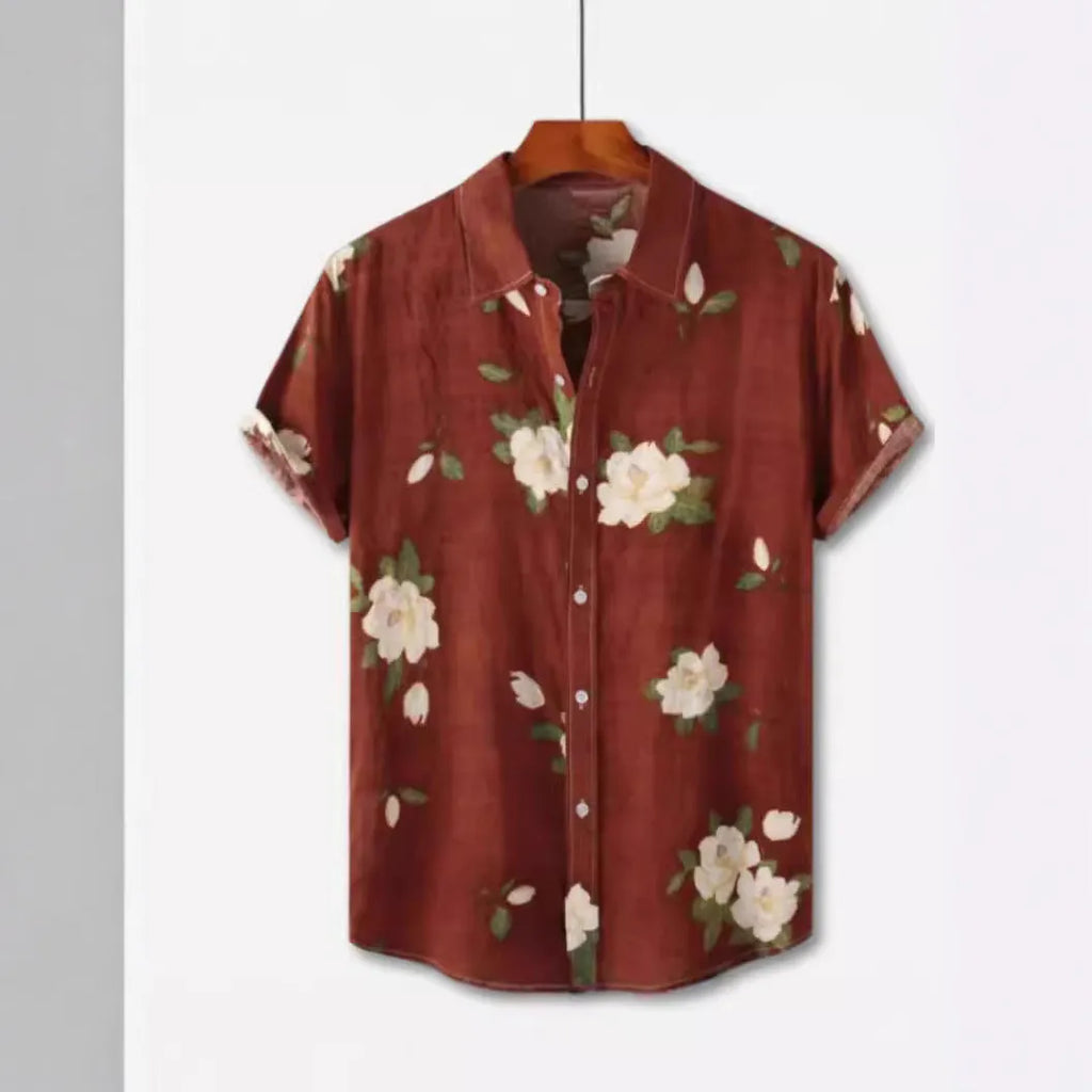 Man wearing a short sleeve Hawaiian shirt with a blue and white floral digital print and a lapel collar.