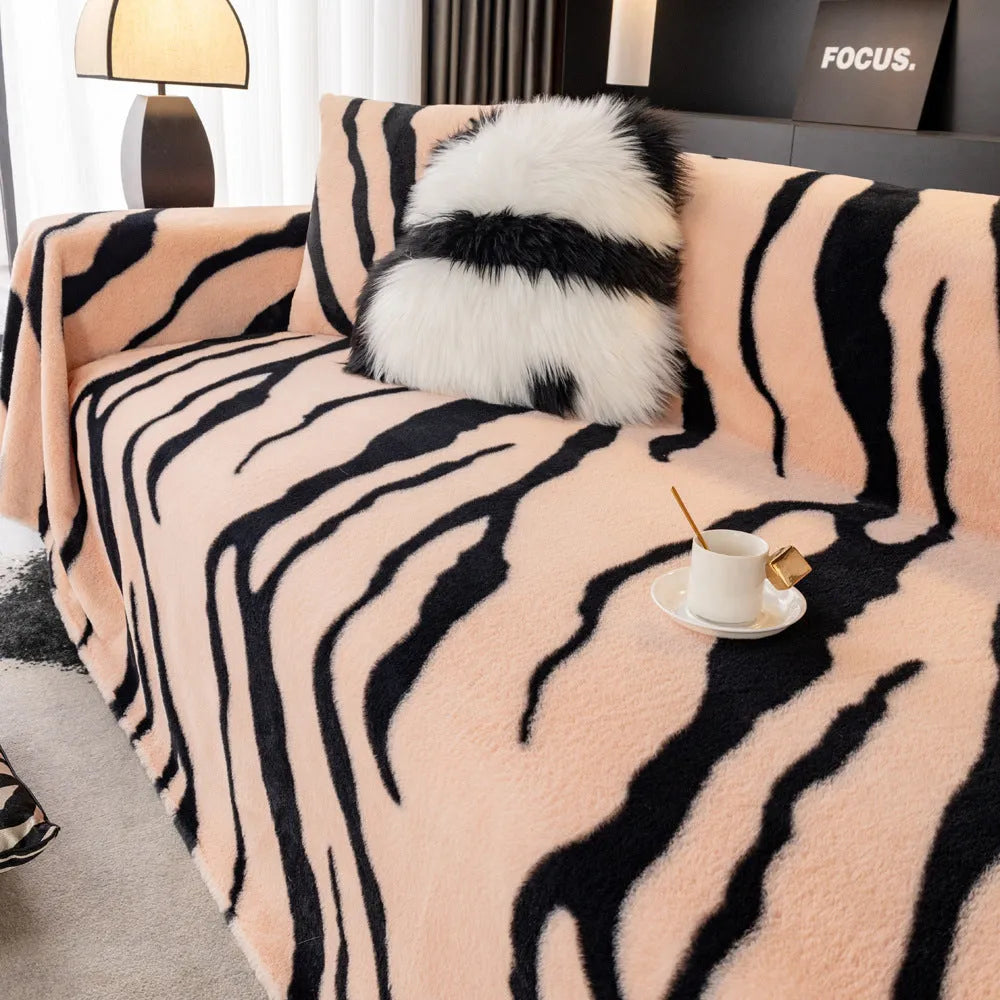 Zebra pattern flannel sofa cover in a caramel colour, shown draped over a sofa.