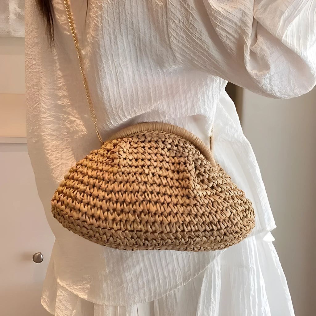 Women's woven straw shoulder bag with shell shape in khaki colour featuring chain detail
