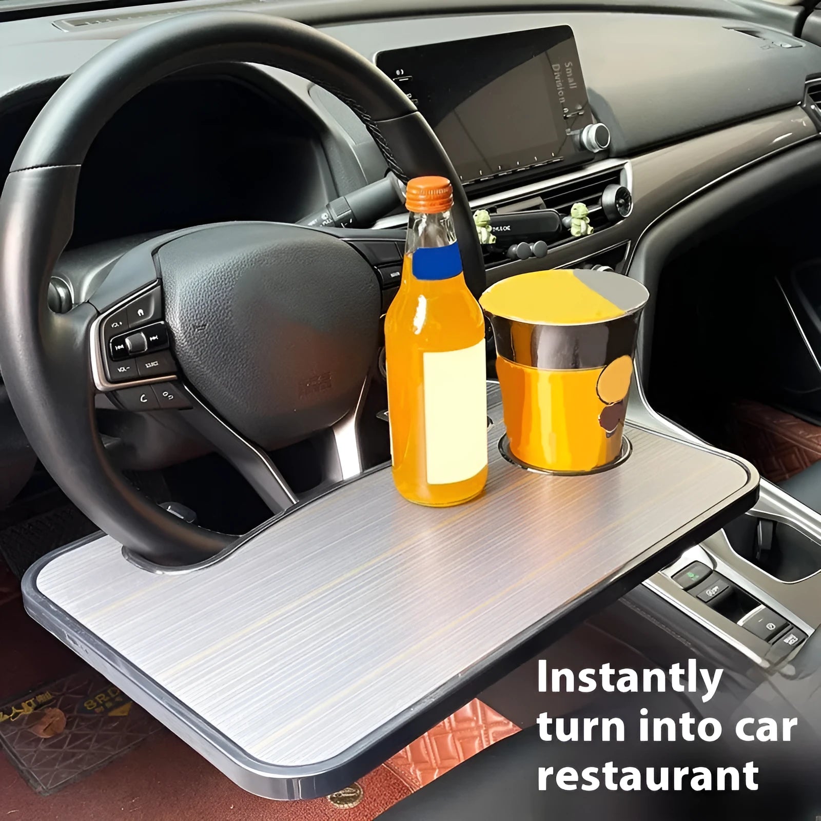 Black ABS car steering wheel laptop stand with foldable drink holder mounted in vehicle