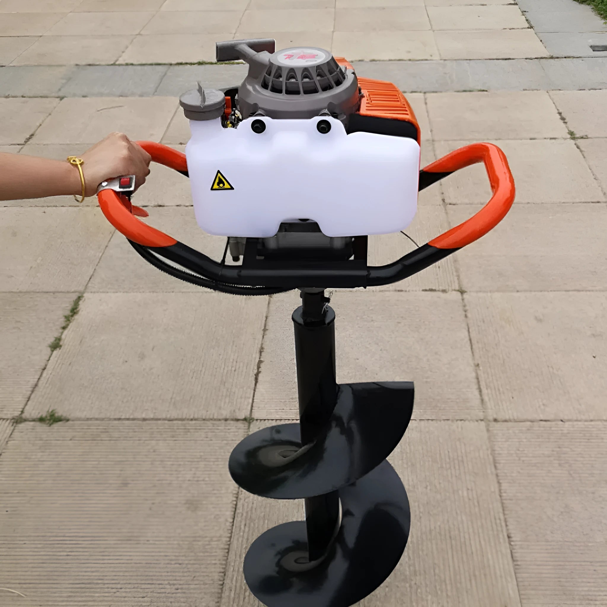 Portable single-person gasoline hole digger for fruit tree fertilization, shown with engine and digging attachment