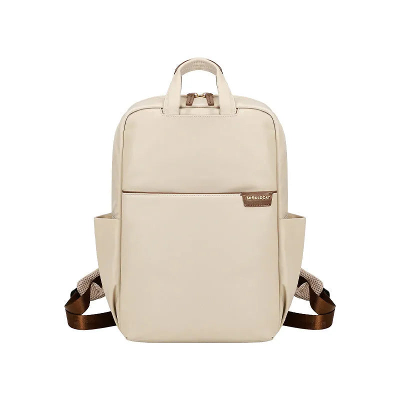 Large nylon women's travel backpack in apricot colour showing internal laptop compartment and multiple pockets.