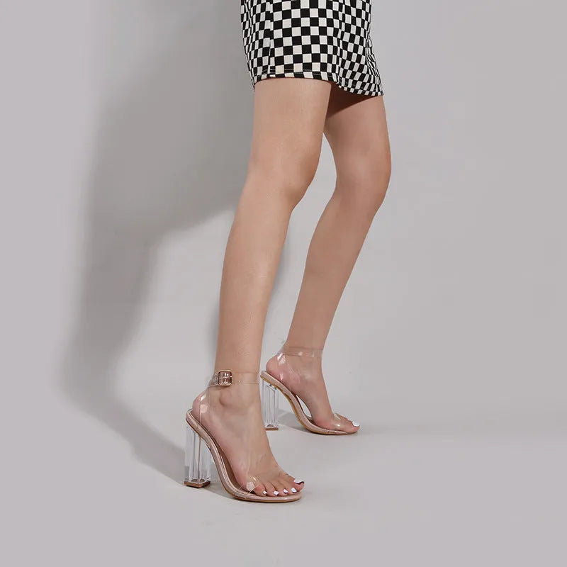 Women's apricot sandals with transparent glass heels and round toe design, showing buckle fastening