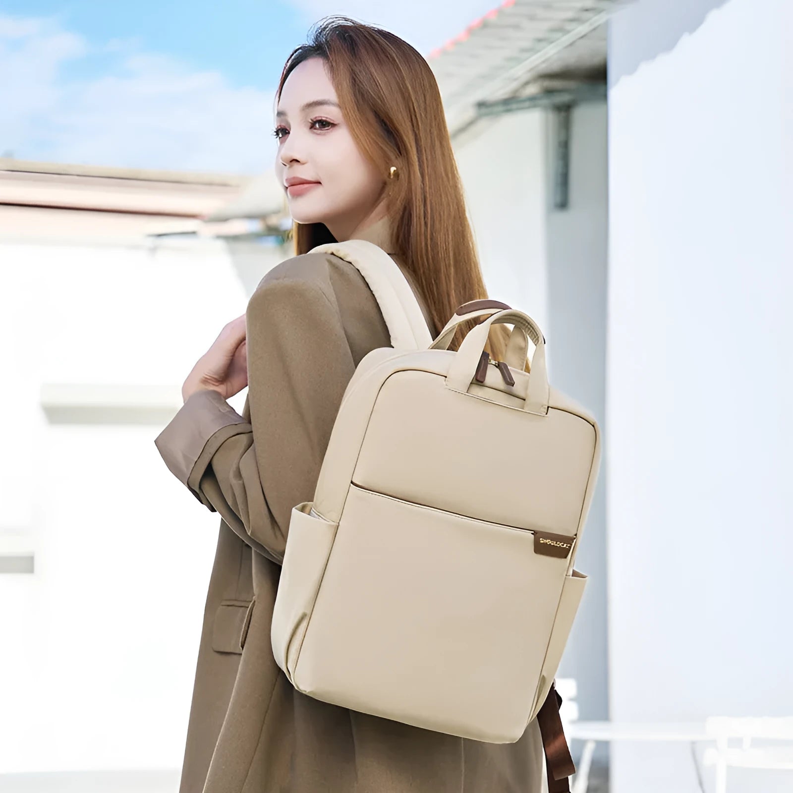 Large nylon women's travel backpack in apricot colour showing internal laptop compartment and multiple pockets.