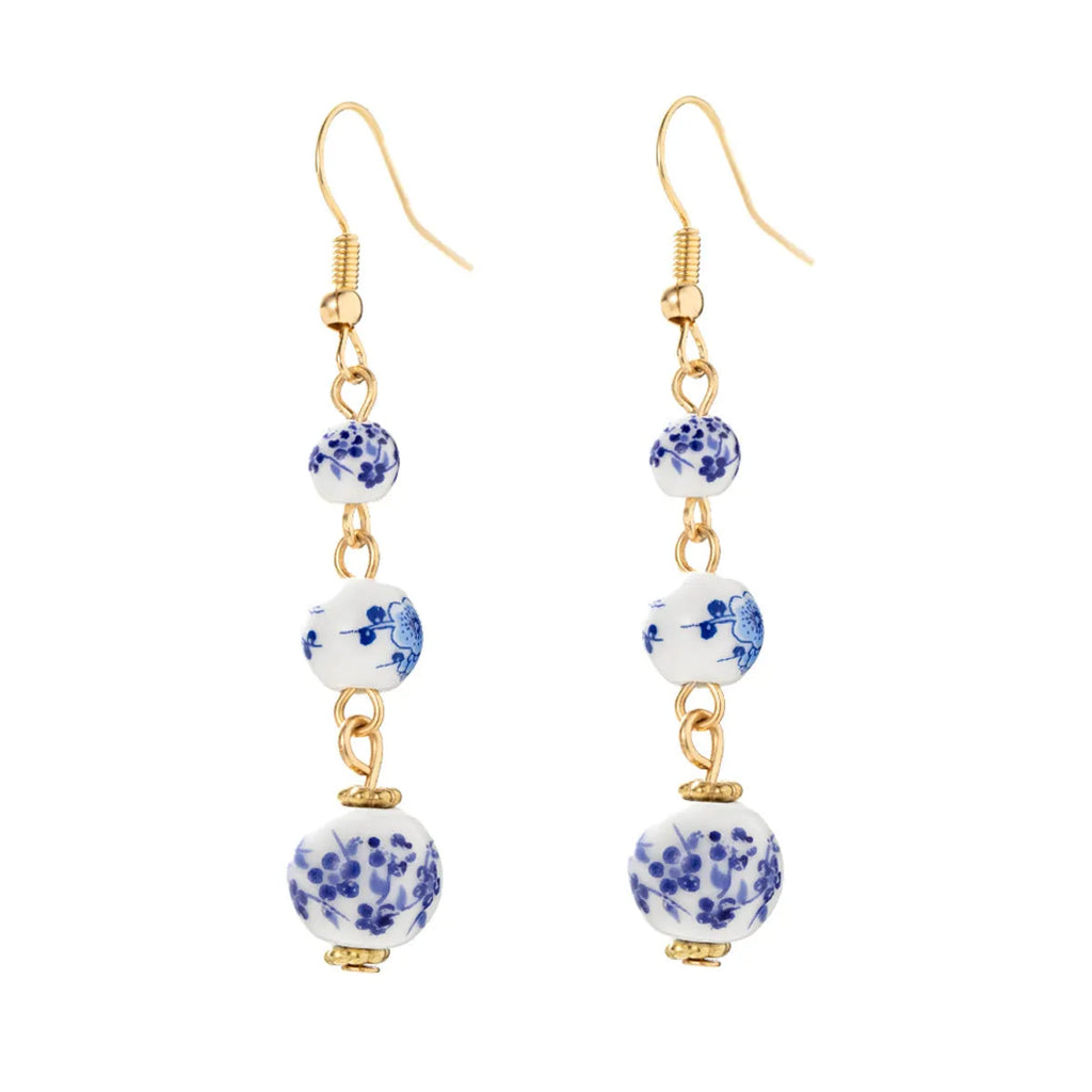 Long retro earrings with blue and white ceramic beads and geometric alloy parts.