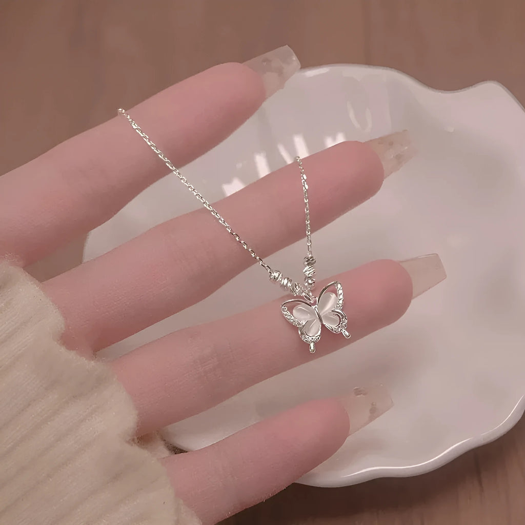 925 sterling silver opal butterfly pendant necklace on a silver adjustable cross chain.