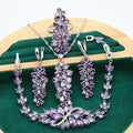 Retro jewellery set with plant pattern designs showing necklace, bracelet, earrings and ring pieces