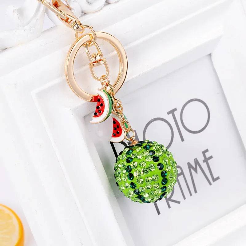 Green watermelon shaped zinc alloy keychain with diamond detailing measuring 12cm length