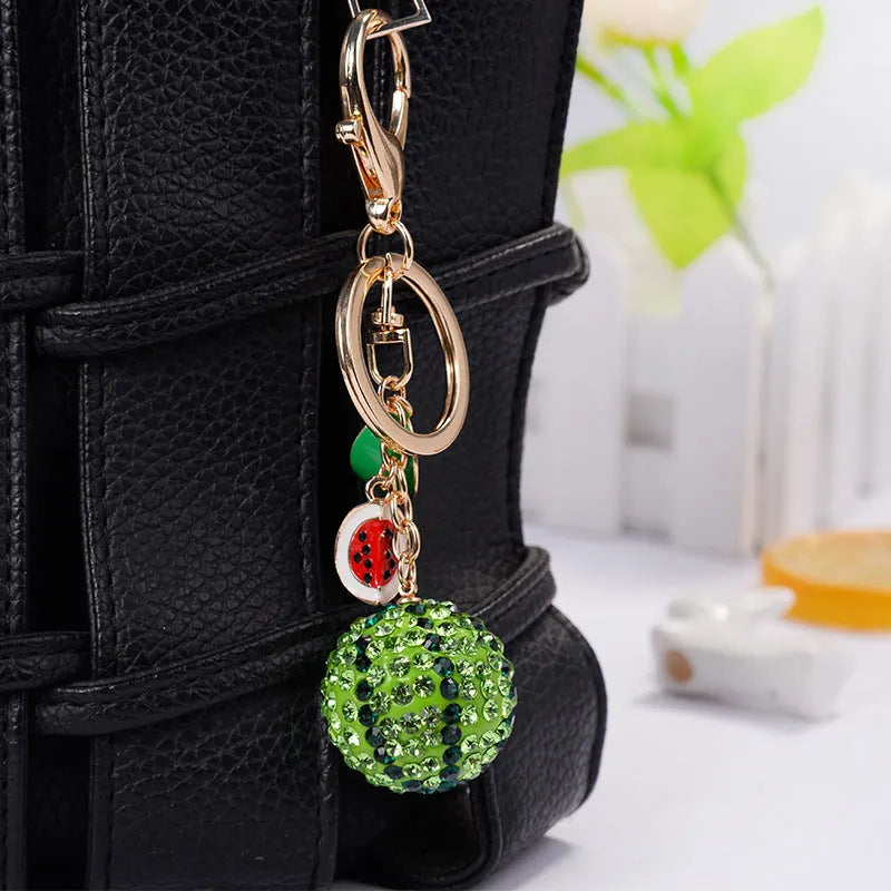 Green watermelon shaped zinc alloy keychain with diamond detailing measuring 12cm length