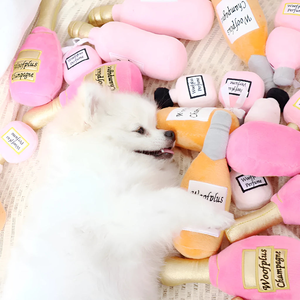 Soft plush pet toy shaped like a wine bottle in assorted colours including green, red, and black.