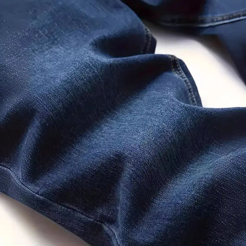 Dark blue men's slim fit casual jeans with mid waist and skinny leg style.