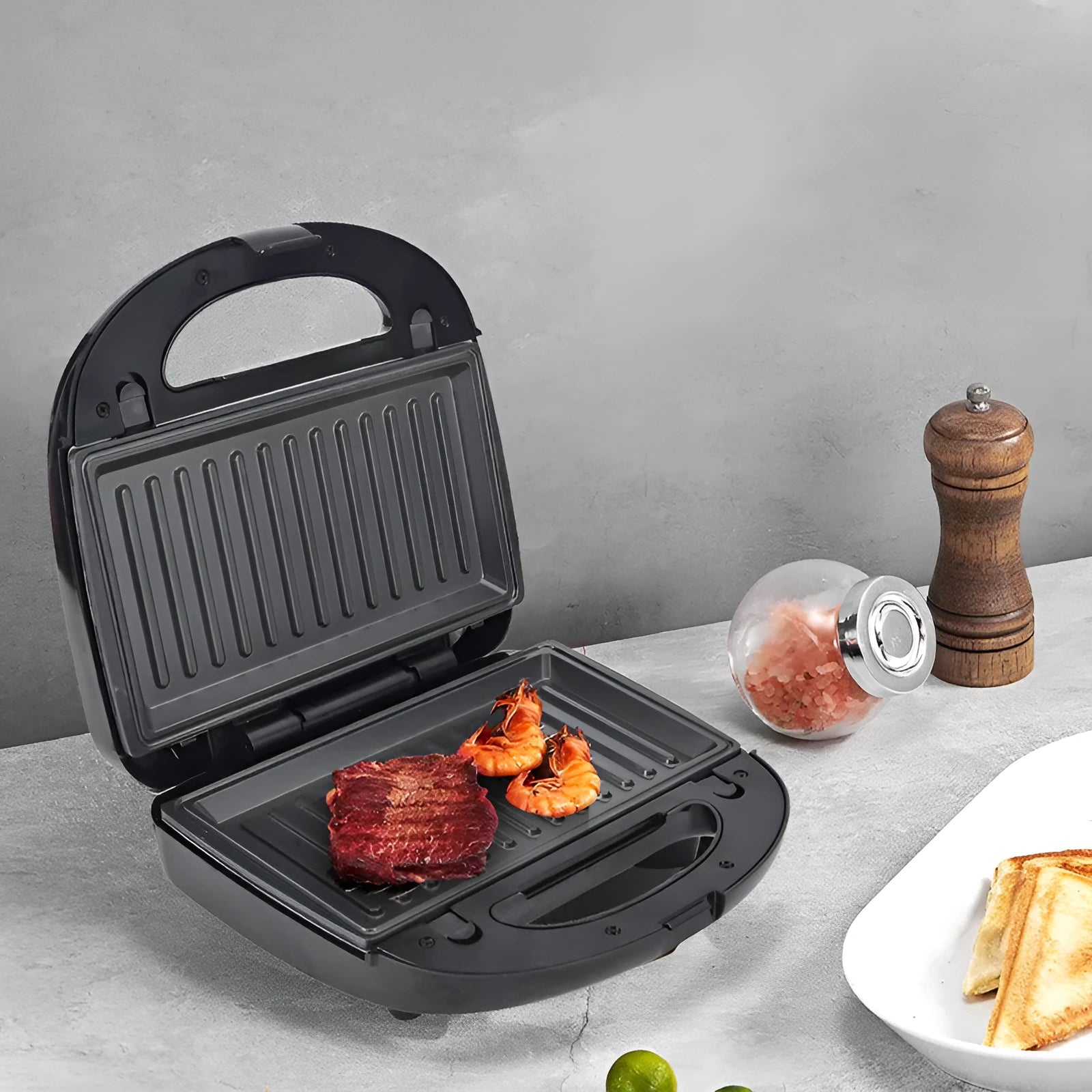 Black double-sided electric sandwich pan with non-stick plates and brushed stainless steel lid
