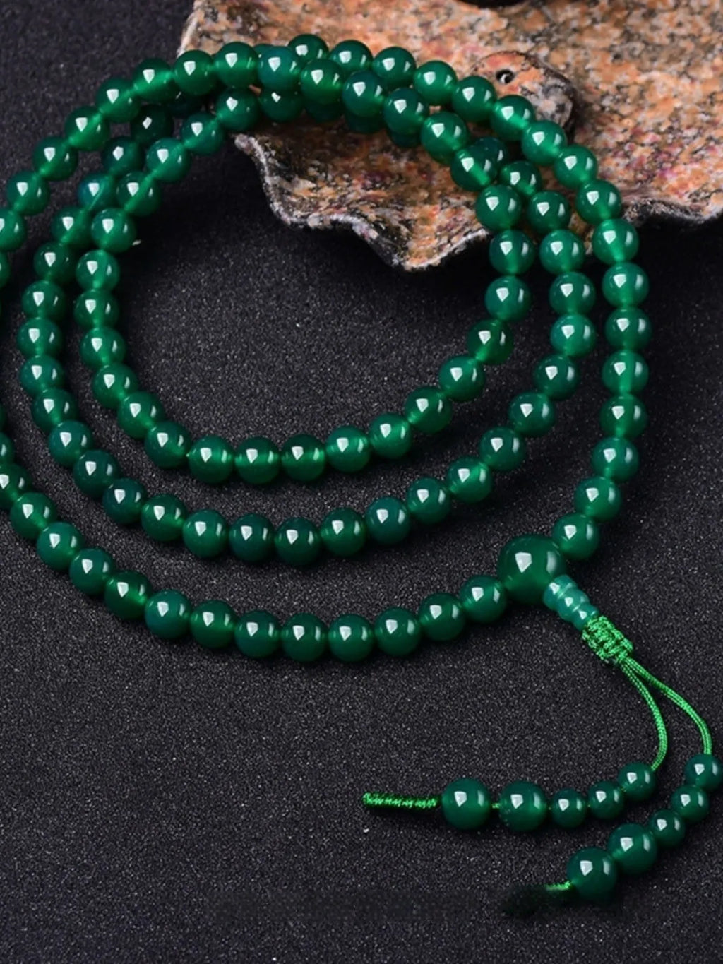 Handmade natural green agate Thangka pendant multi-circle bracelet on wrist.