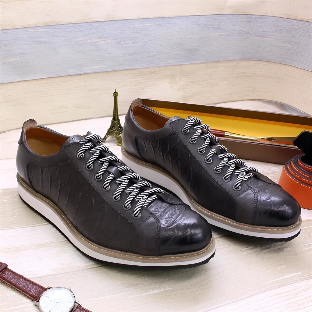 Men's white low-top casual shoes with a patterned embossed upper and front lace closure.