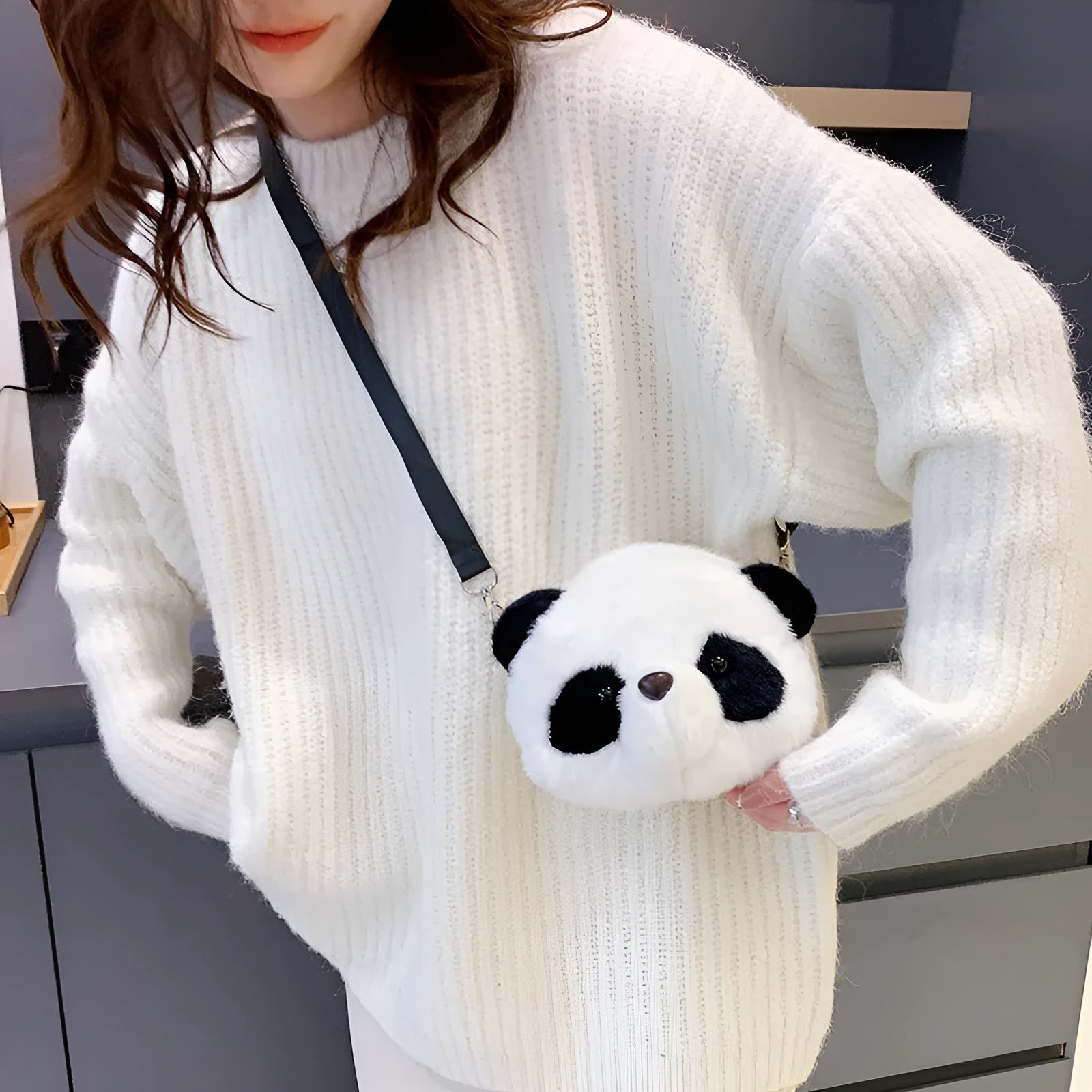 Soft plush cylindrical panda head crossbody bag showing front sandwich pocket.