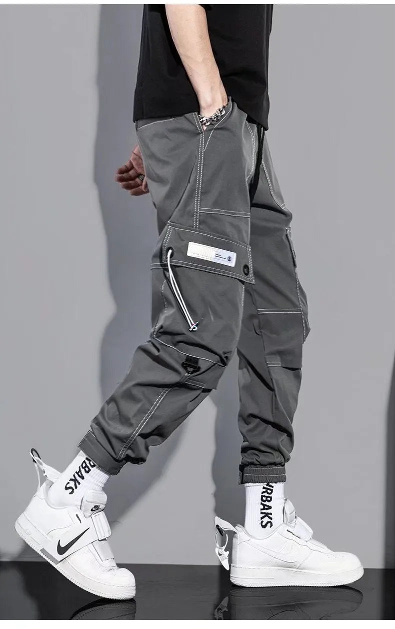 Men's loose fit solid colour polyester trousers in gray, front view, for casual autumn wear