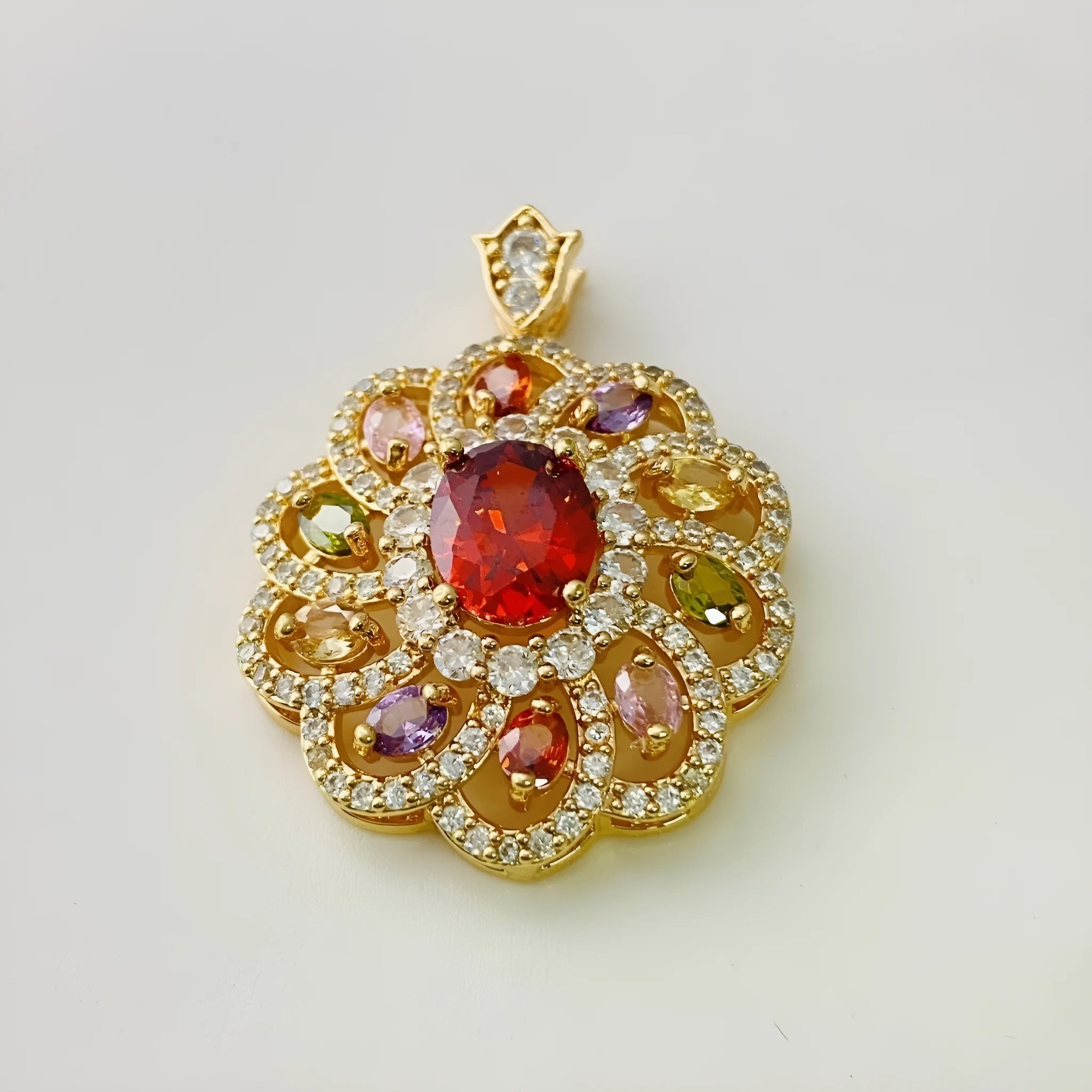 Close-up of a women's colourful zircon flower pendant necklace with a gold electroplated finish on a model.