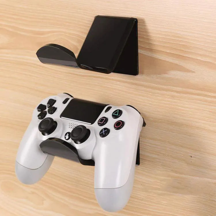 Universal plastic wall mount bracket holding a game controller, shown in black, white, and transparent colour options.