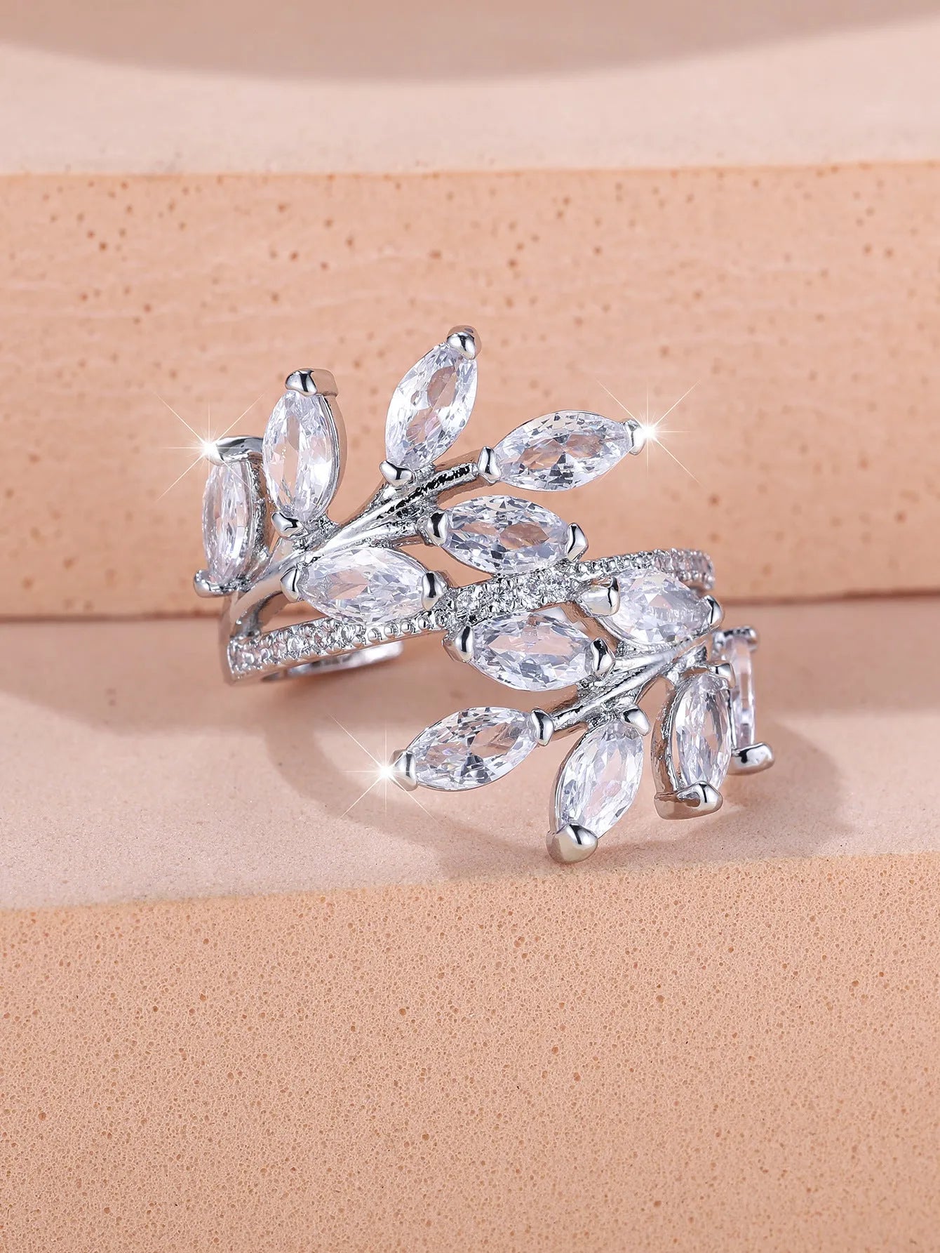 Adjustable horse eye design leaf ring in copper with zircon crystals, shown in a rose gold finish