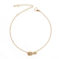 Women's alloy bracelet with a pineapple charm in gold or silver tone on a wrist.